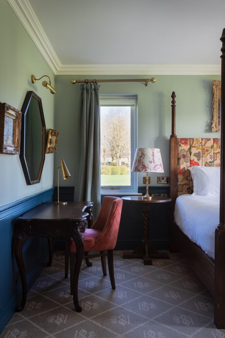 Hotel bedroom with colourful headboard and natural light
