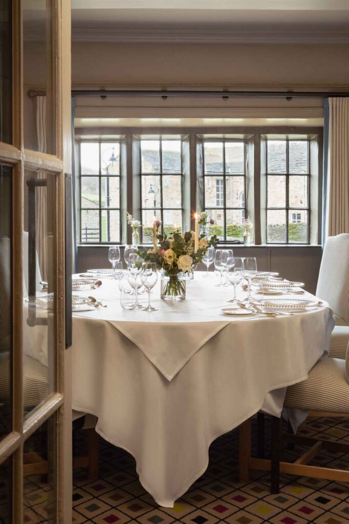 shot of a wedding reception dinner table with an open door in the foreground