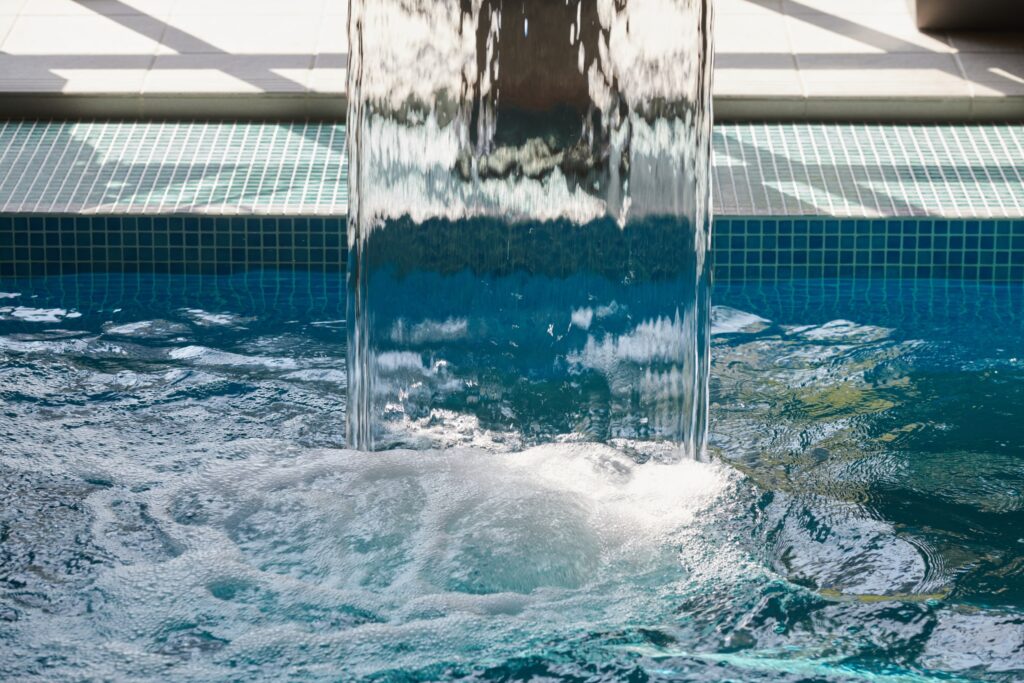 close up of spa fountain bubbling in s swimming pool