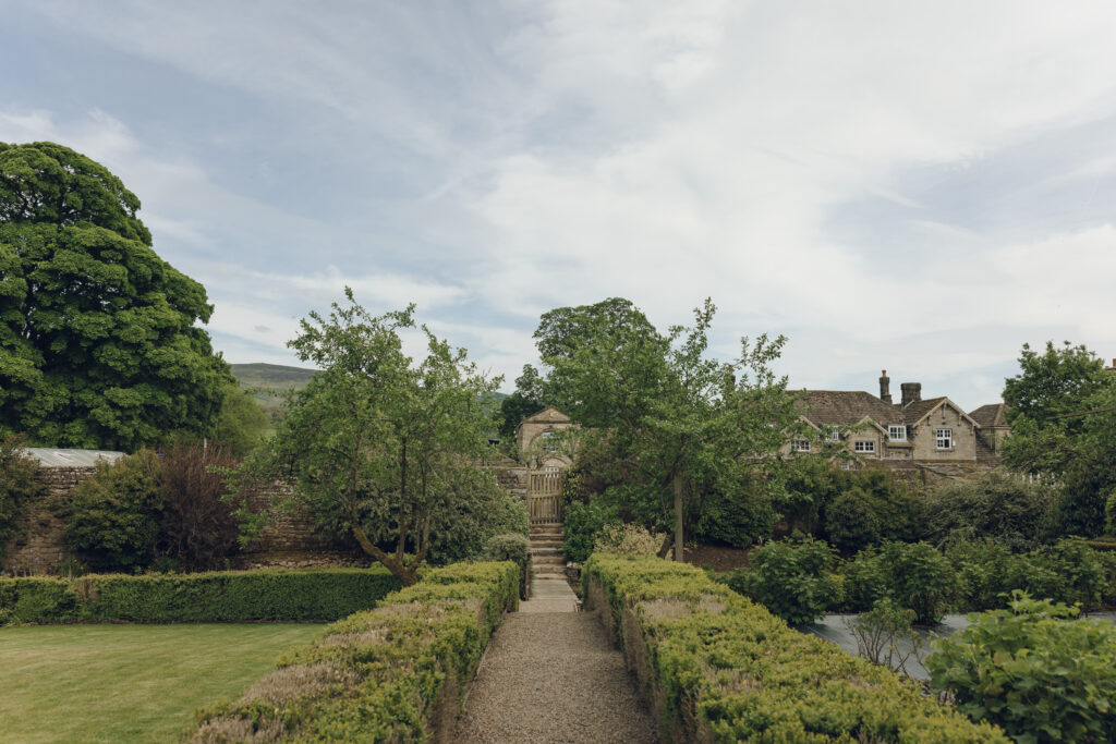 The kitchen garden with a small path through the vegetable beds towards some more vegetable beds.