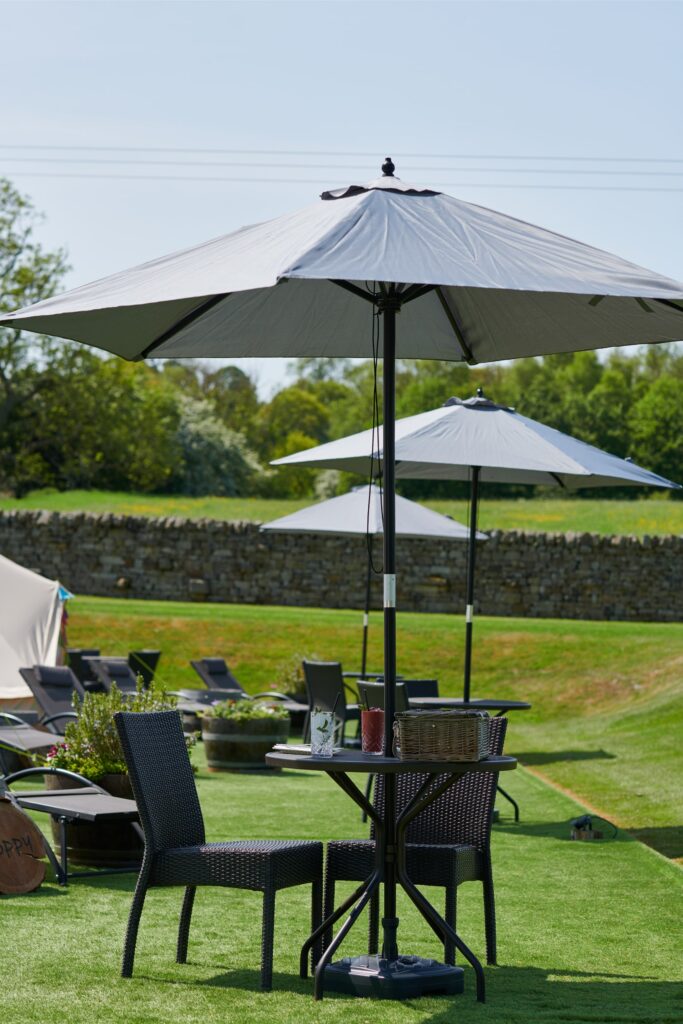 The Spa tents outside with the outdoor tables and chairs.