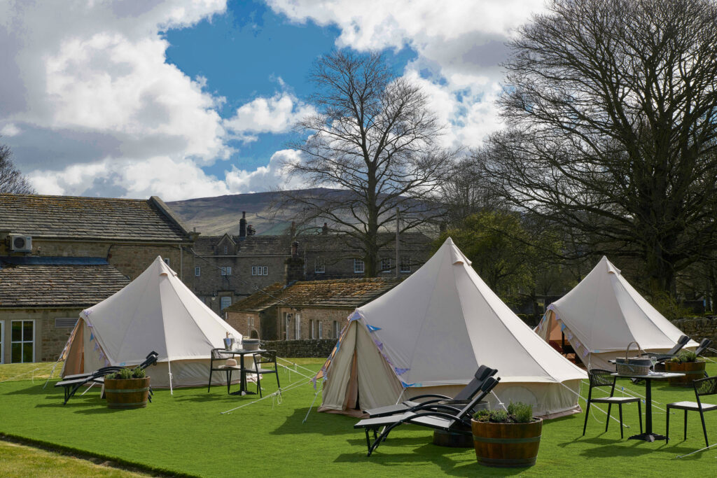 The Spa tents outside with the outdoor tables and chairs.