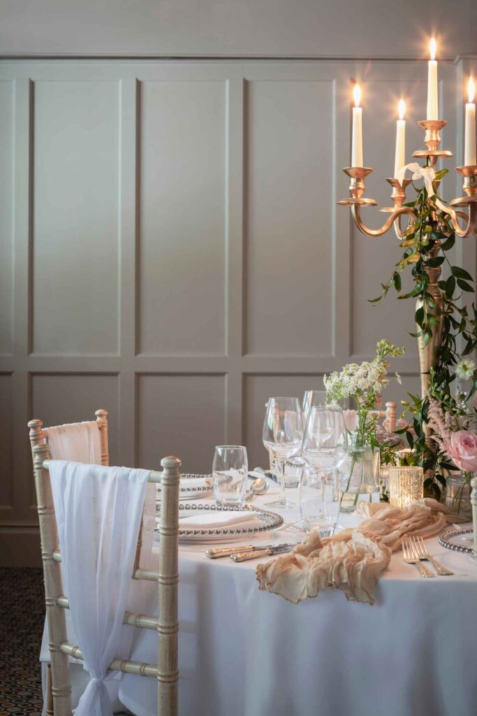 wedding recption table detailing featuring candles and glassware
